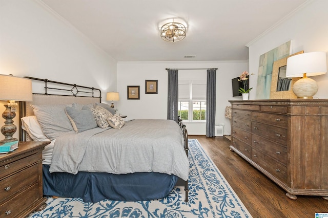 bedroom featuring dark hardwood / wood-style flooring and crown molding