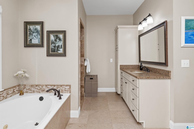 bathroom with vanity, a relaxing tiled tub, and tile patterned floors