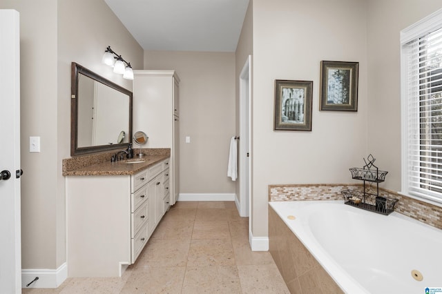 bathroom featuring vanity, tiled tub, and tile patterned flooring