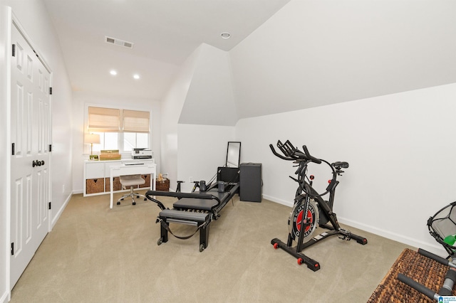 workout room with light colored carpet and lofted ceiling