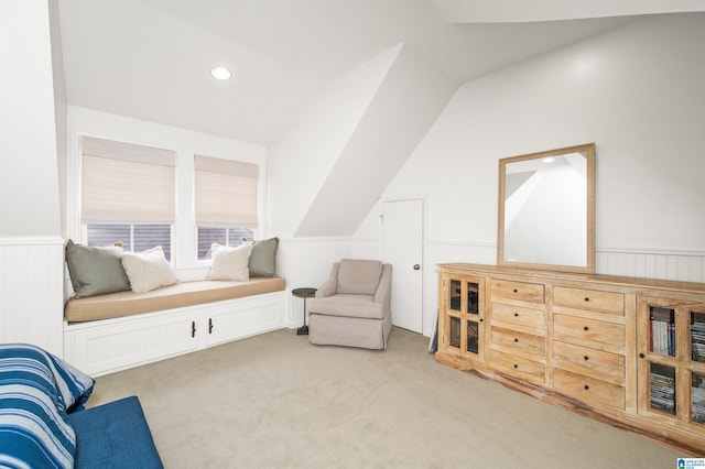 sitting room featuring lofted ceiling and light colored carpet