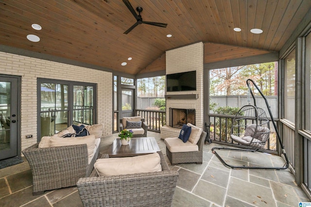 sunroom with vaulted ceiling, wooden ceiling, and plenty of natural light