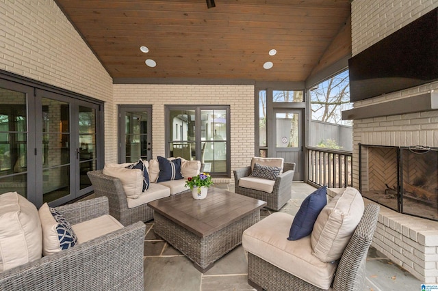 sunroom / solarium featuring an outdoor brick fireplace, vaulted ceiling, and wooden ceiling