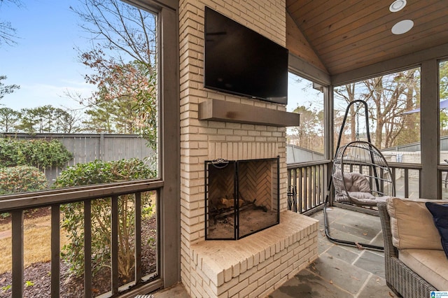 wooden deck featuring a fireplace and a patio area