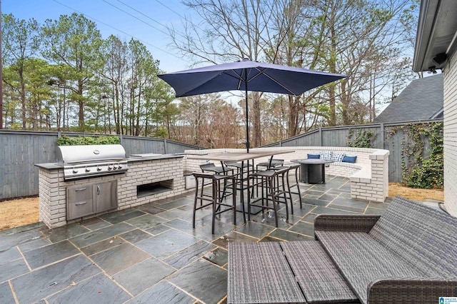 view of patio / terrace featuring a grill and exterior kitchen