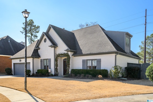 french country style house with a garage