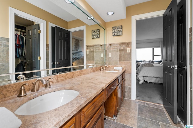 bathroom featuring vanity and tile walls