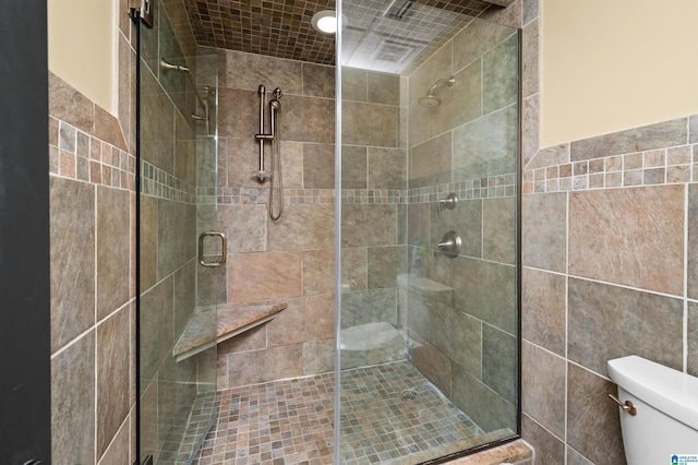 bathroom featuring an enclosed shower and toilet