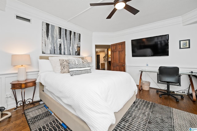 bedroom with crown molding, dark hardwood / wood-style floors, and ceiling fan