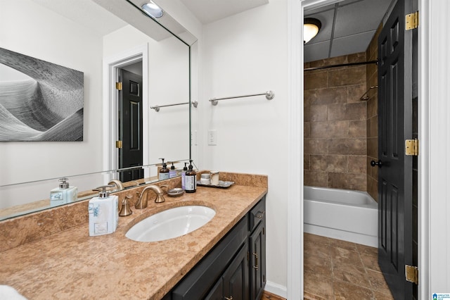 bathroom with tiled shower / bath and vanity