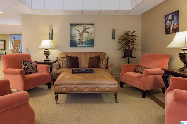 living room with carpet floors and a drop ceiling