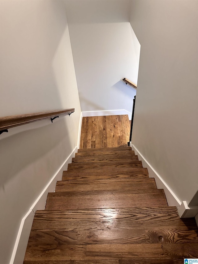 stairs featuring hardwood / wood-style floors