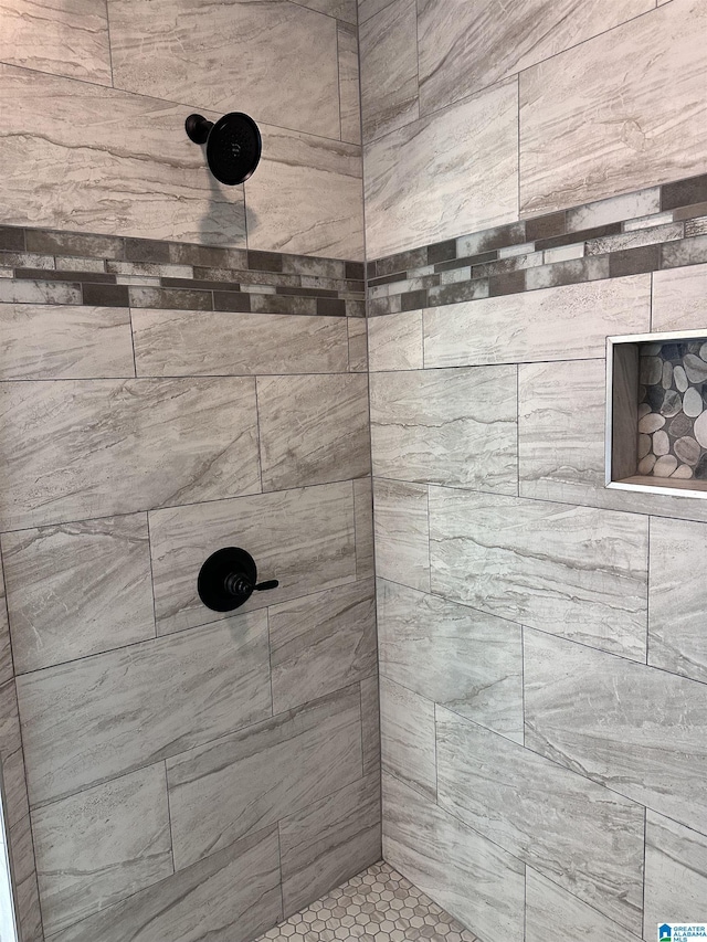 bathroom with a tile shower