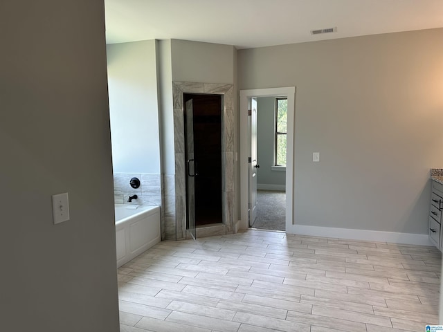 bathroom featuring vanity and plus walk in shower