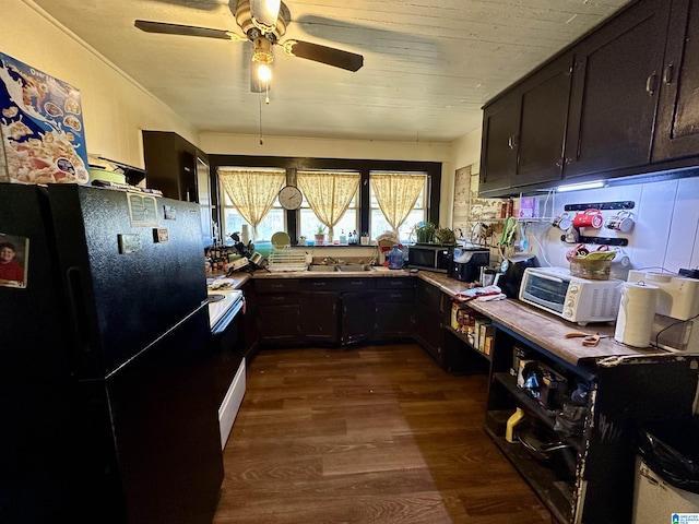 kitchen with ceiling fan, white range with electric cooktop, black refrigerator, dark hardwood / wood-style floors, and dark brown cabinetry