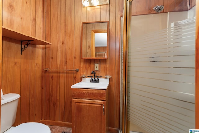 bathroom featuring vanity, an enclosed shower, and wood walls