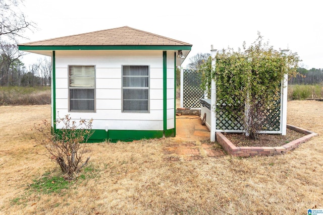 view of side of property with a lawn