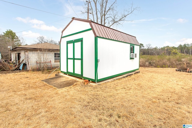 view of outbuilding featuring cooling unit and a yard