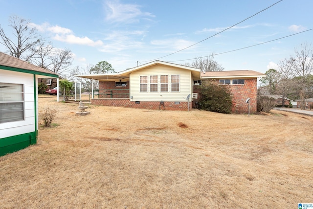 rear view of property featuring a lawn