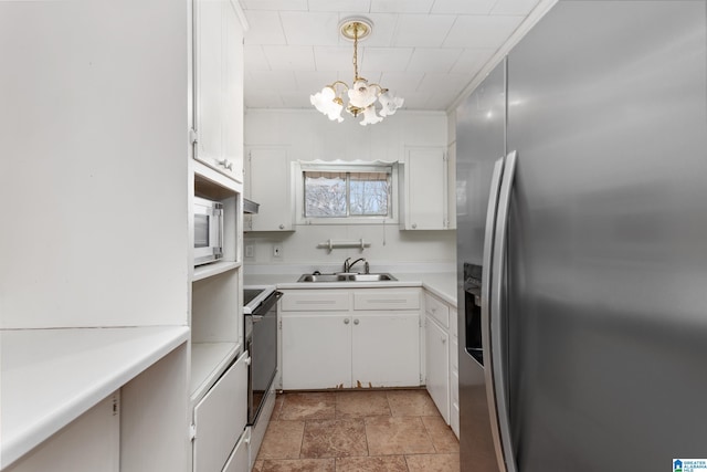 kitchen with white cabinetry, appliances with stainless steel finishes, sink, and hanging light fixtures