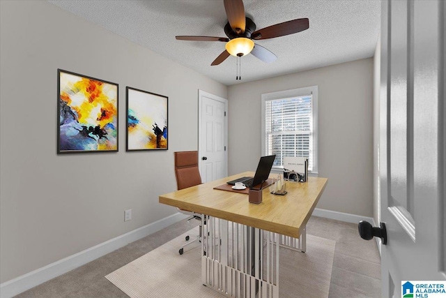 home office with ceiling fan, light carpet, and a textured ceiling