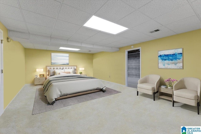 bedroom featuring a paneled ceiling and carpet floors