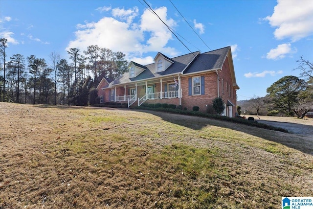 view of front of home with a porch, a garage, and a front lawn