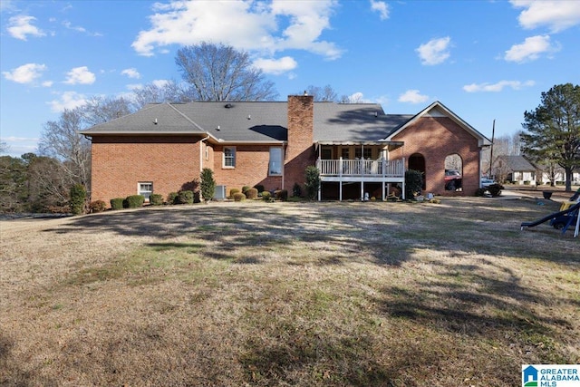 back of property with cooling unit and a lawn