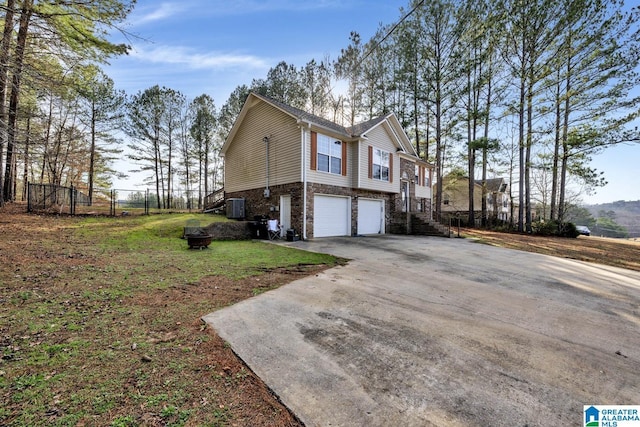 view of side of home featuring a garage and a lawn