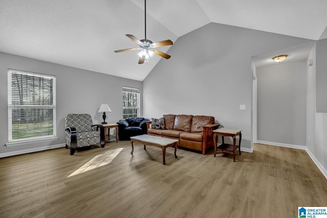 living room featuring ceiling fan, high vaulted ceiling, and light wood-type flooring