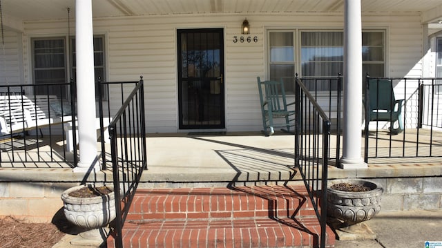 view of exterior entry with covered porch