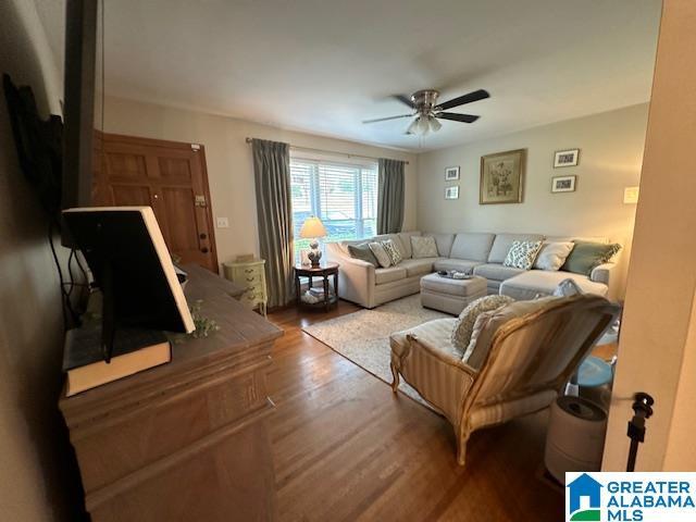 living room with hardwood / wood-style flooring and ceiling fan