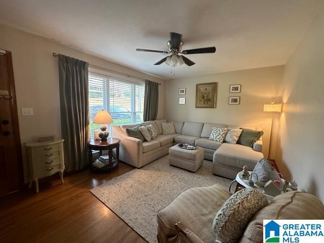 living room with ceiling fan and dark hardwood / wood-style floors