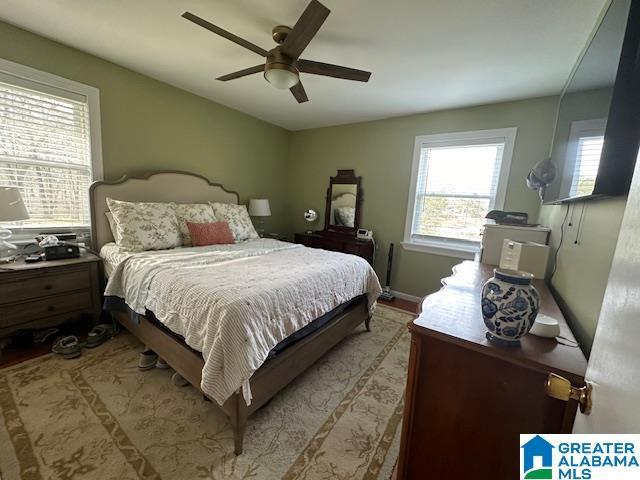 bedroom with light wood-type flooring and ceiling fan