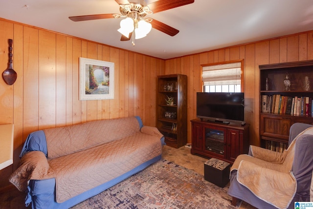 living room featuring ceiling fan and wood walls