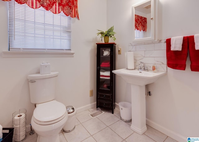 bathroom with toilet, tile patterned floors, and decorative backsplash