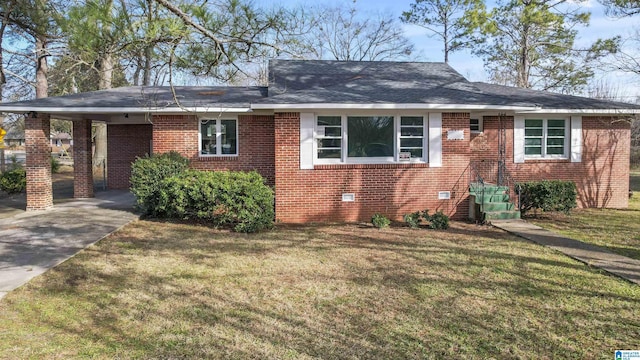 ranch-style house with a front yard and a carport