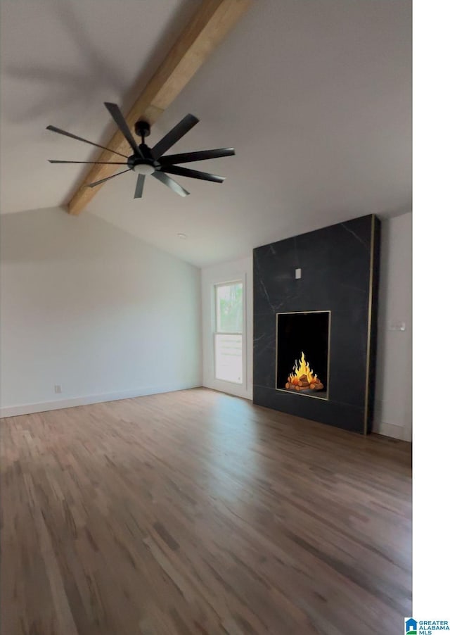 unfurnished living room featuring hardwood / wood-style floors, a high end fireplace, lofted ceiling with beams, and ceiling fan