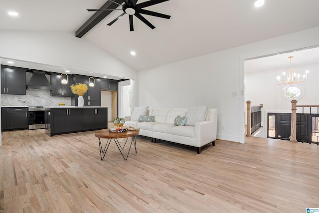 living room with beamed ceiling, ceiling fan with notable chandelier, high vaulted ceiling, and light hardwood / wood-style flooring