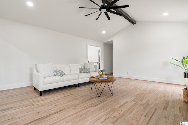 living room featuring ceiling fan, light hardwood / wood-style flooring, and vaulted ceiling with beams