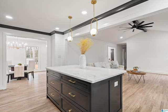 kitchen featuring decorative light fixtures, lofted ceiling with beams, light wood-type flooring, a kitchen island, and light stone countertops