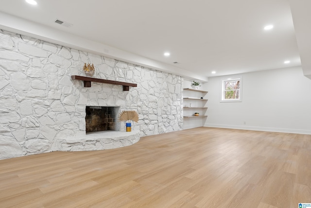 unfurnished living room featuring light hardwood / wood-style flooring and a fireplace