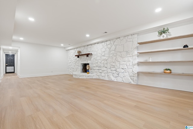 unfurnished living room with a fireplace and light hardwood / wood-style flooring