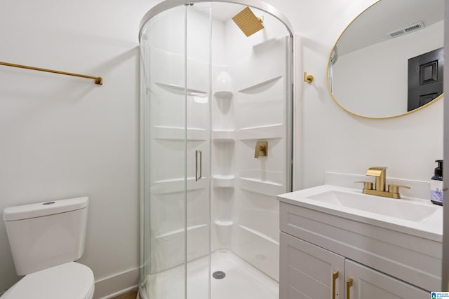 bathroom with vanity, toilet, and a shower with shower door