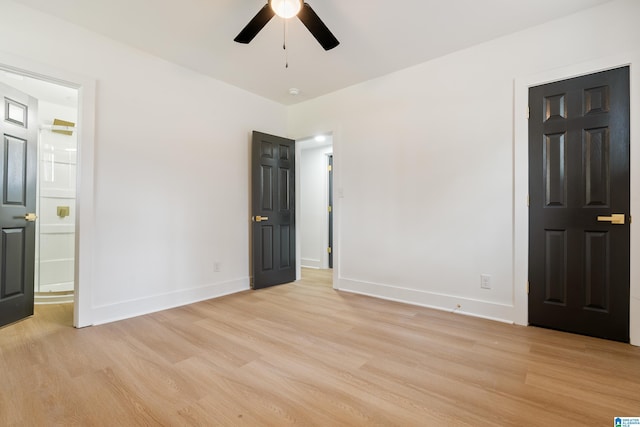 unfurnished bedroom with light hardwood / wood-style floors, ceiling fan, and ensuite bathroom