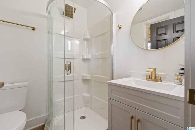 bathroom featuring vanity, toilet, and an enclosed shower