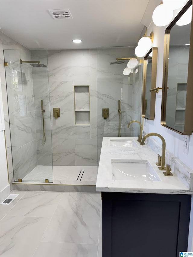 bathroom featuring a tile shower and vanity