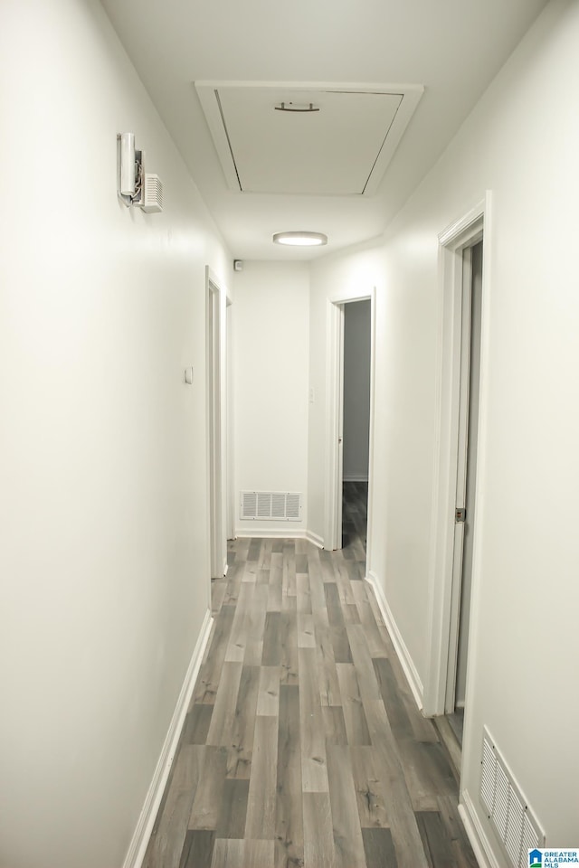 hallway with hardwood / wood-style floors