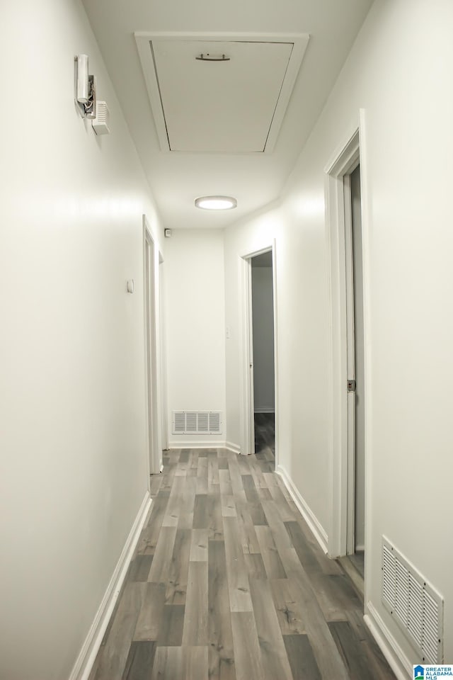 hallway with dark hardwood / wood-style flooring