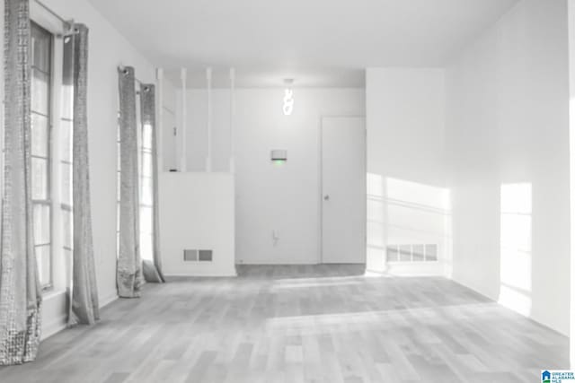 unfurnished room with light hardwood / wood-style floors